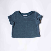 A short-sleeve crewneck baby tee in a muted slate blue color, laid flat on a white background.