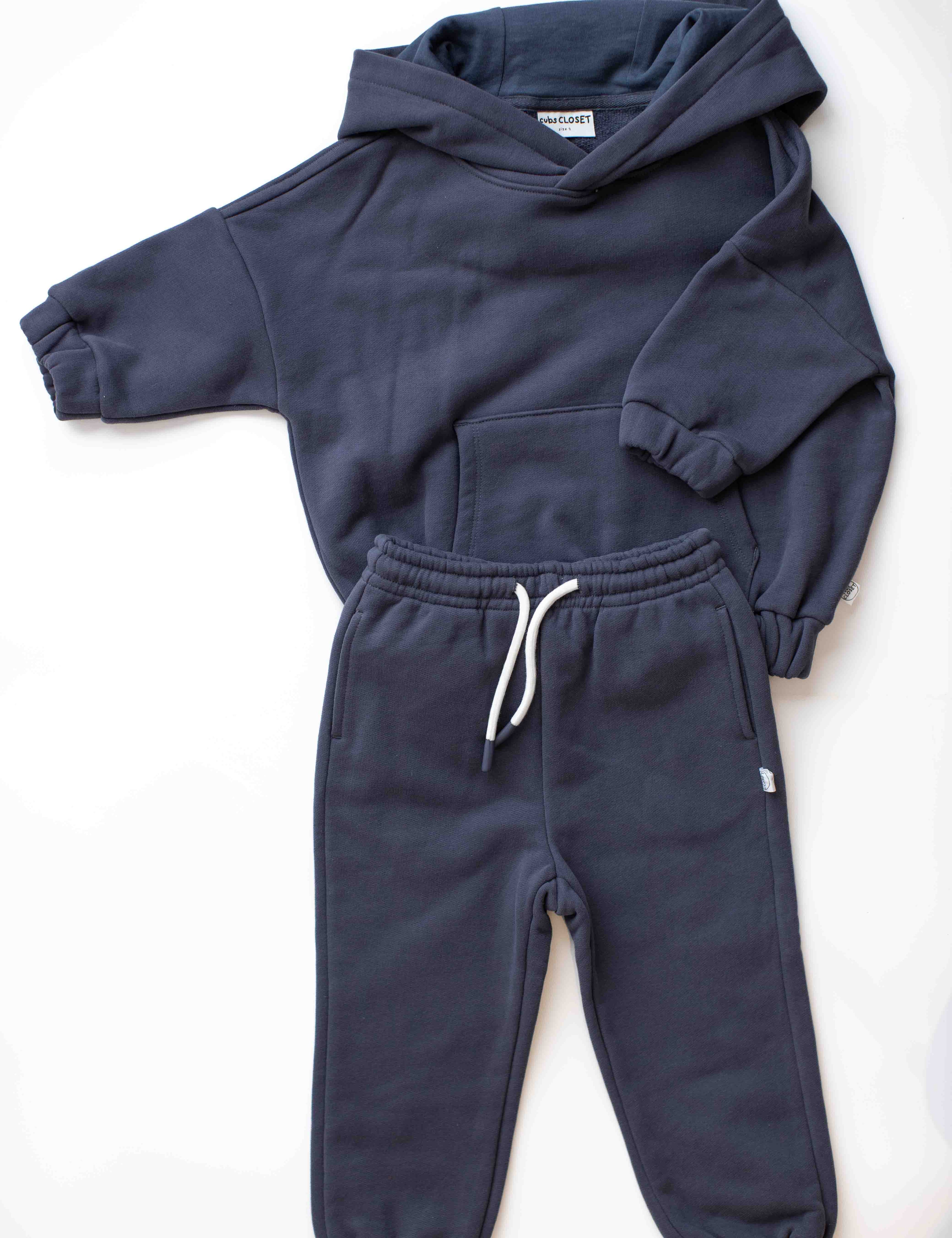 Navy blue hoodie and jogger set on a white background